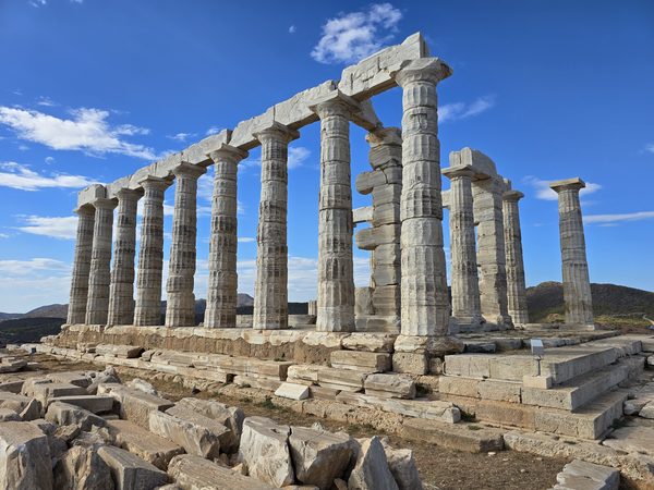 The Temple of Poseidon at Cape Sounion, its rows of marble columns standing against a clear blue sky