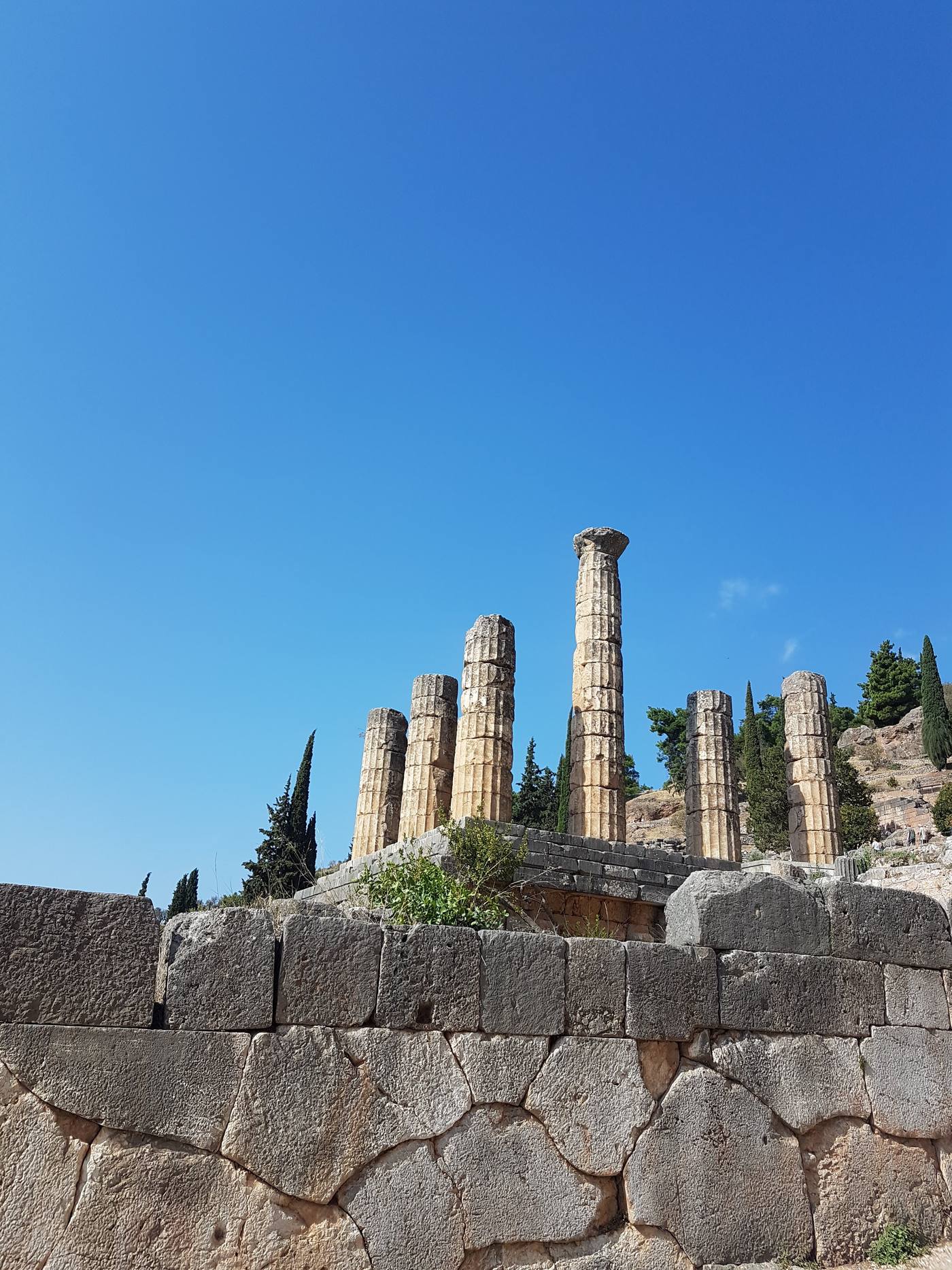 Columns of the Temple of Apollo rising against the mountainside at the Sanctuary of Delphi
