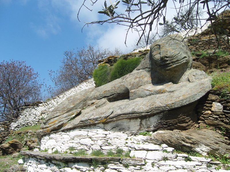 Ancient stone lion carved into rock face near Ioulida on Kea island, showing the enigmatic half-smile of this 6th-century BC sculpture